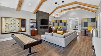 Lounge/wet bar with shuffleboard, tvs and fireplace